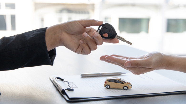 handing over a car key