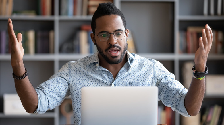 Frustrated man with laptop
