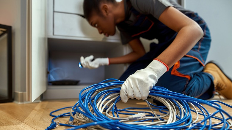 person holding network cables