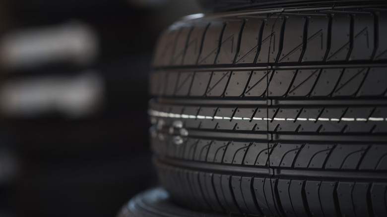 Close-up of stacked car tire showing tread