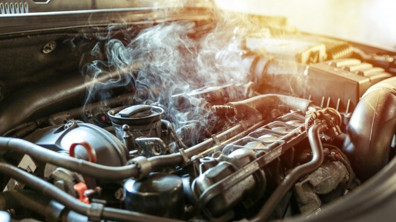an overheating car engine with steam