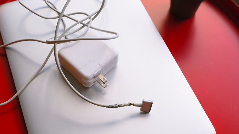 Laptop charger with twisted cable near port