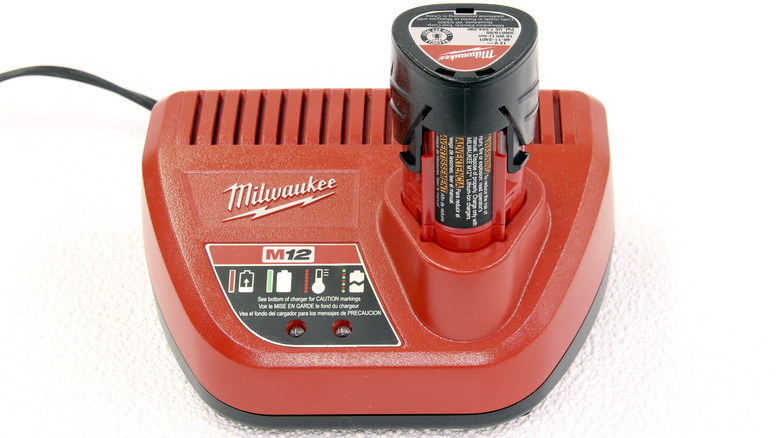 Milwaukee Battery and carger on a white surface