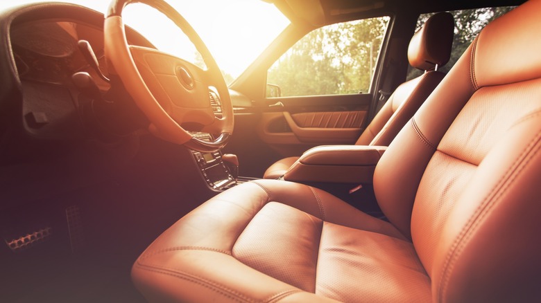 Brown leather car interior with golden sun rays pouring into it