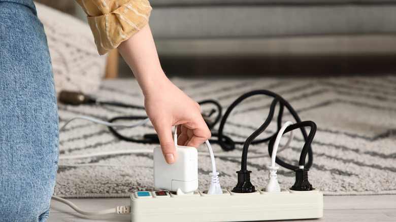 A woman connecting a charger to an extension