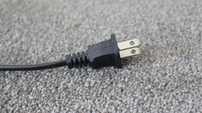a black power cord over a carpet