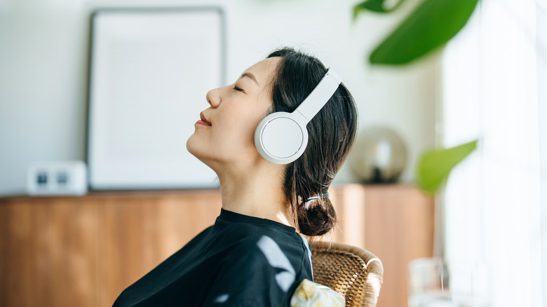 A person sitting with headphones on.