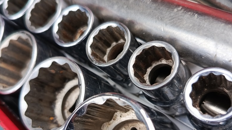 Several chrome sockets in a tool box.