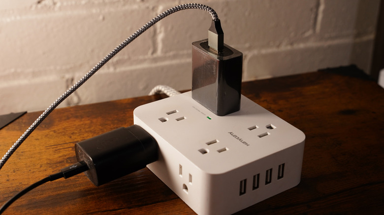 Surge protector with multiple devices and cables plugged into it