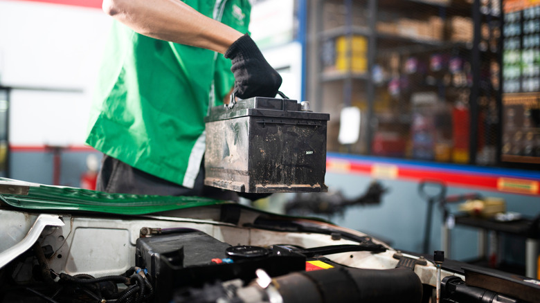A Mechanic Changing Out A Dead Battery