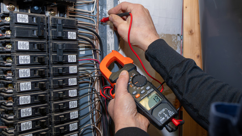 An inspector testing a circuit breaker