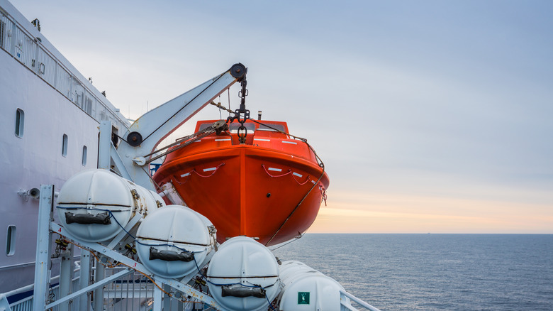 An orange lifeboat on a cruise ship
