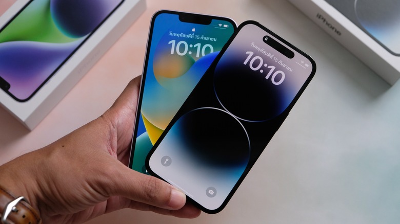 two iPhones held in hand