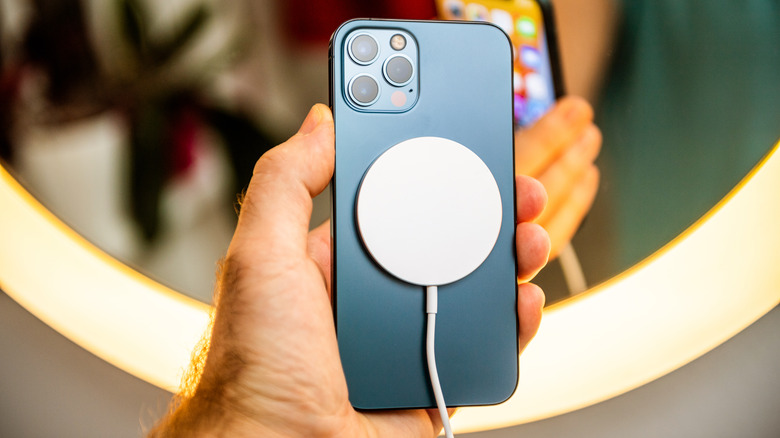 An iPhone connected to a wireless charger.