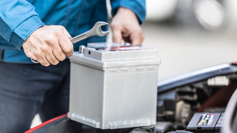 Mechanic installing a new car battery