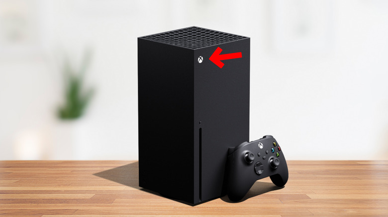 Xbox Series X on a table with arrow towards power button