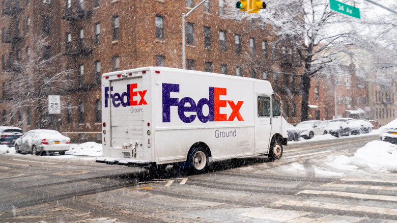 FedEx truck driving in snow
