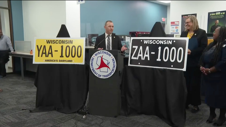 The Governor of Wisconsin demonstrating the new license plate designs at a press conference