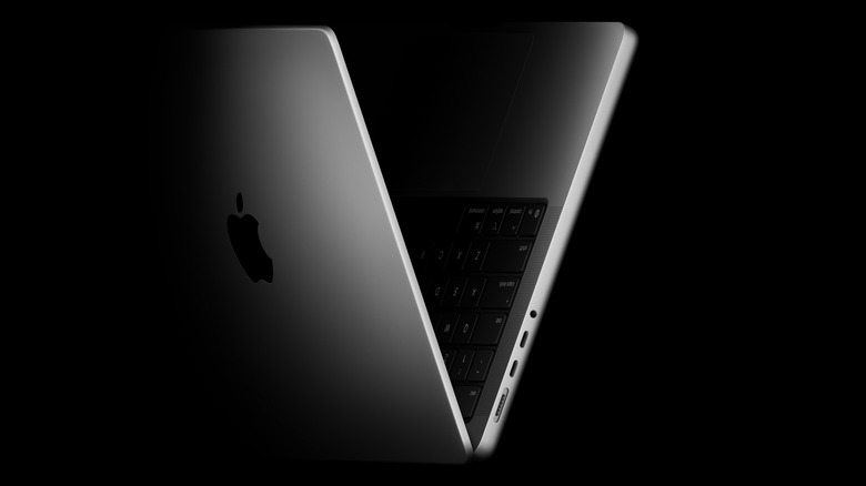 The side edges of the new M5 MacBook Pro, with the laptop folded to form a V shape, black background