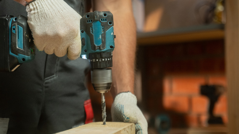 woodworker using drill to make something