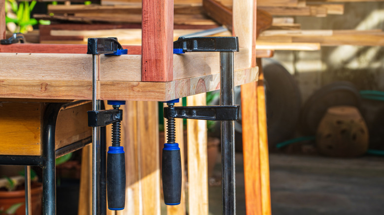 F-clamps holding a workpiece to a bench