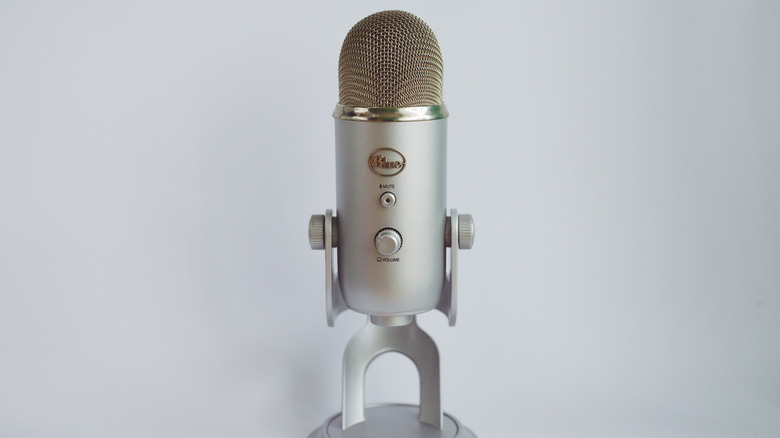 A blue Yeti microphone on a gray backdrop.
