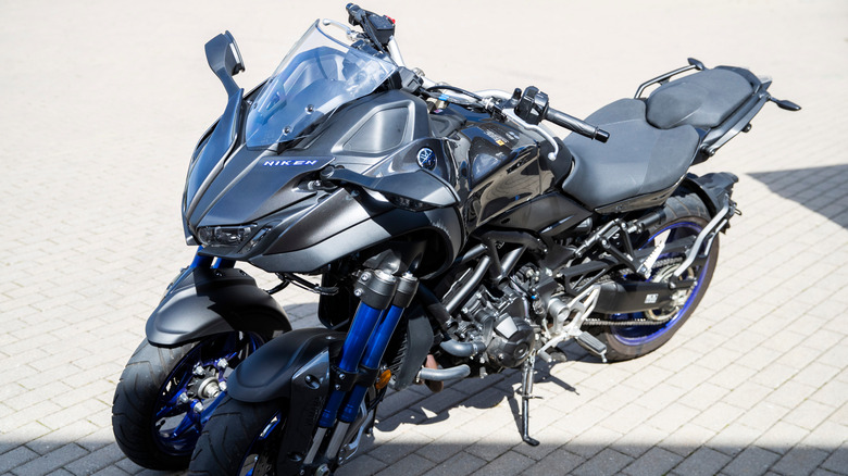 Black and blue Yamaha Niken parked on paving stones