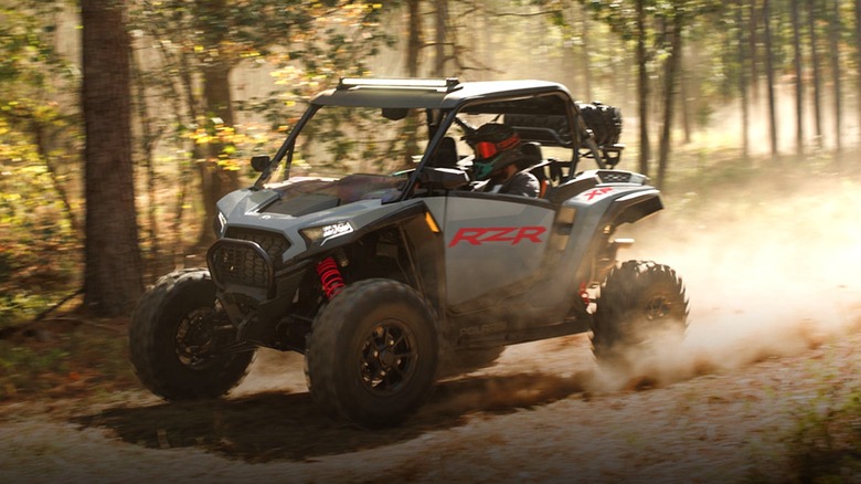 Person driving Polaris RZR on a trail
