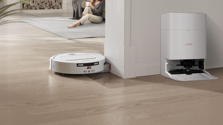 The YEEDI M14 PLUS cleaning near its docking station