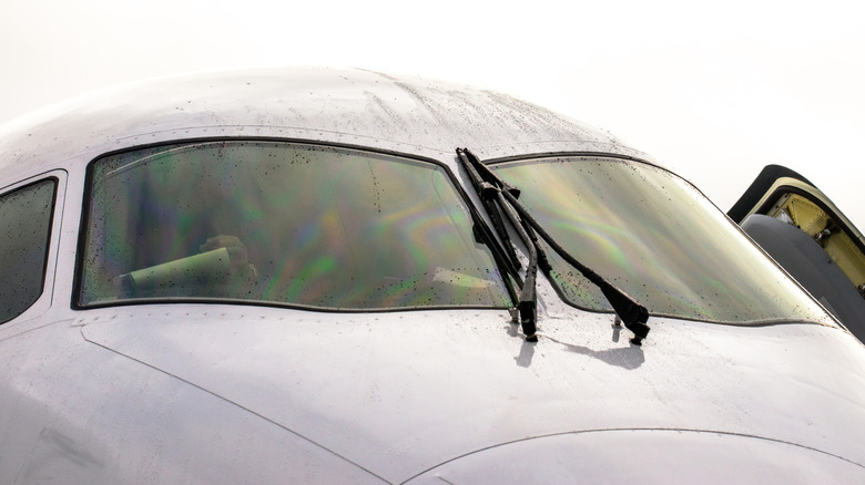 Airplane on ground with windshield wipers and raindrops