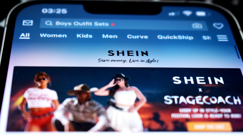 Person shopping for boys outfit sets on Shein app