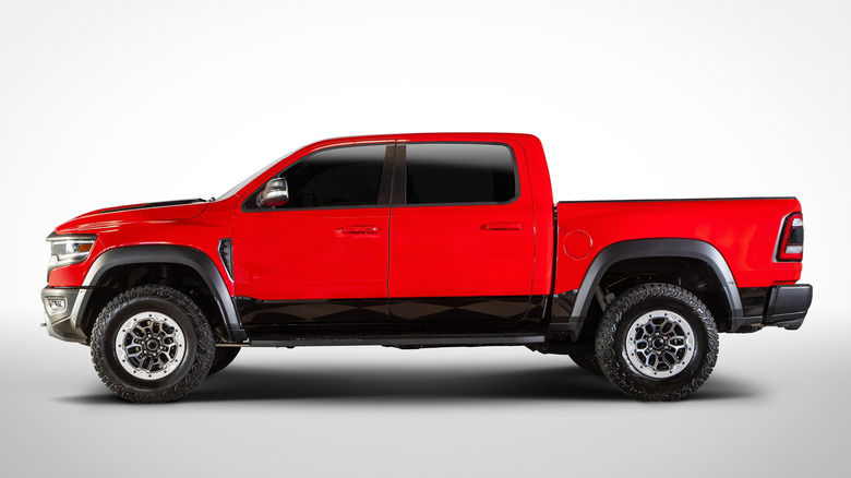 Side view of red pickup truck in studio
