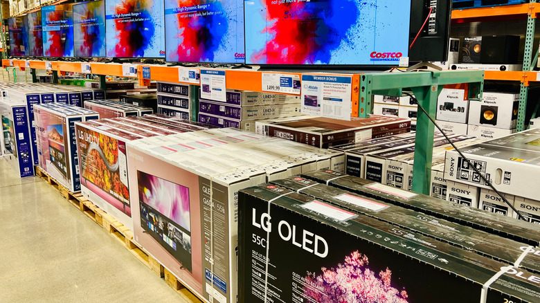 Large HDR and OLED televisions for sale inside Costco warehouse.