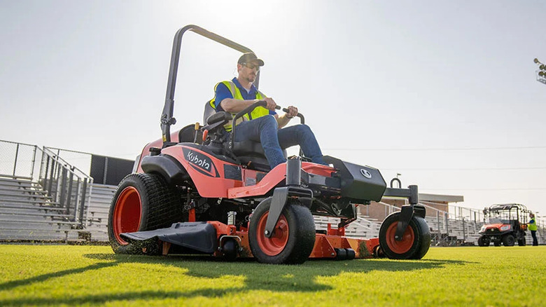 A person on a Kubota ZD1611 diesel lawn mower