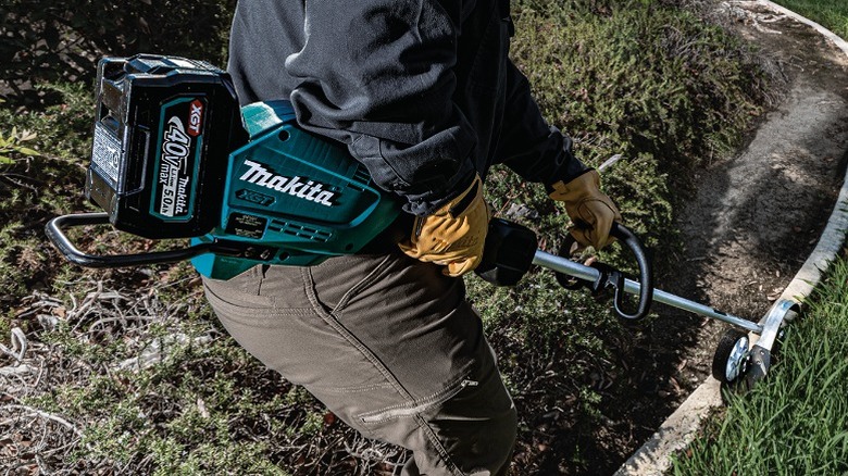 Person using 40V Max XGT Cordless Edger on curb