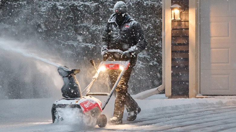 A man using the Milwaukee snow blower