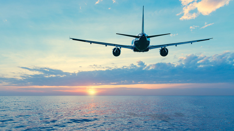 Plane flying over the ocean