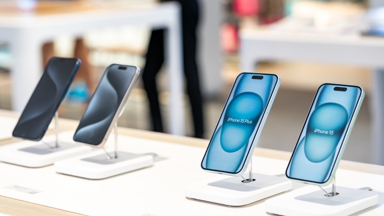 iPhone 15 models displayed in a store