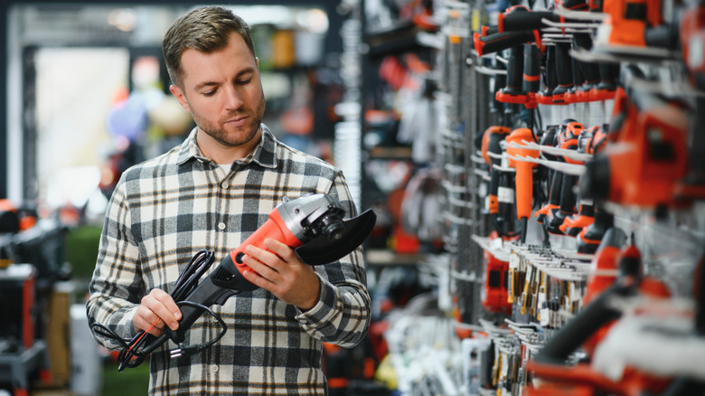 Man holding a tool at power tool store
