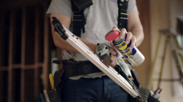 A man using WD-40 Silicone Spray