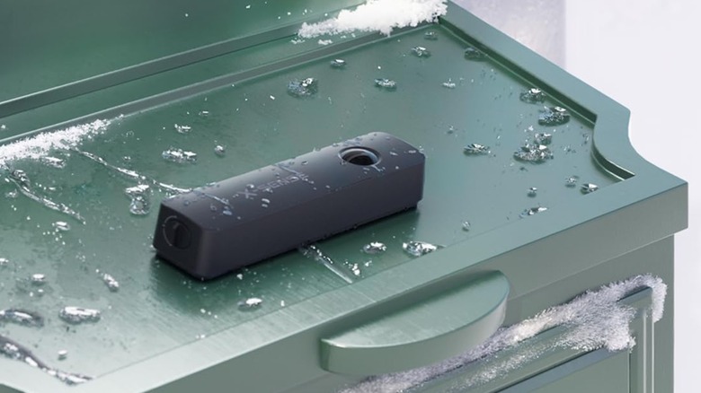 an X-Sense Smart Mailbox Sensor installed on a mailbox during winter