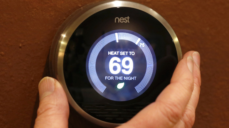 A Third-Generation Nest Smart Thermostat Being Adjusted