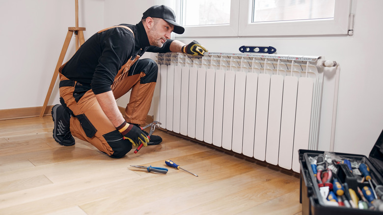 a technican fixing a heating system