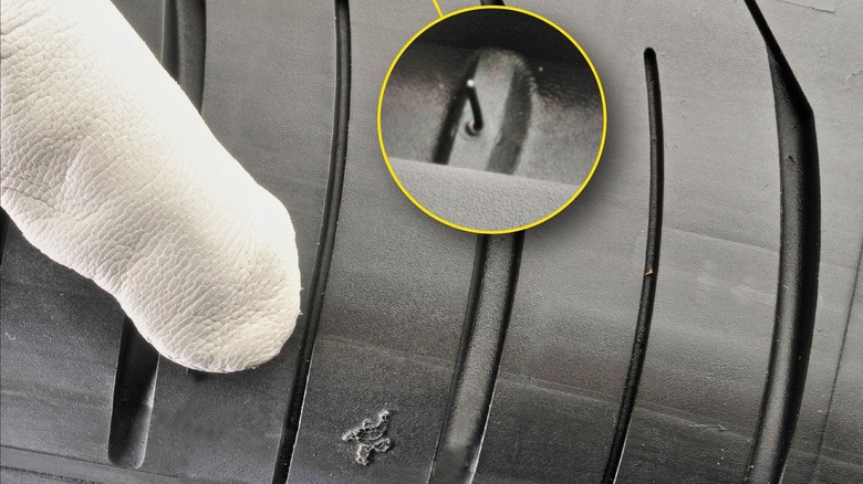 Michelin Man symbol on tire pointing to wear bar