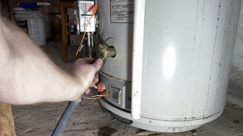 a man cleans his water heater tank