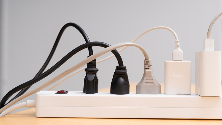A power strip with lots of devices plugged in.