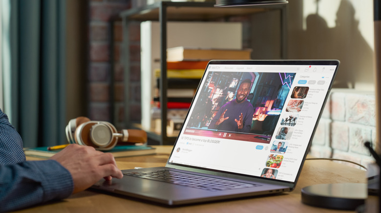 Person watching YouTube on laptop