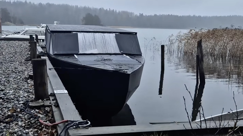 The solar yacht docked in a lake in wintertime
