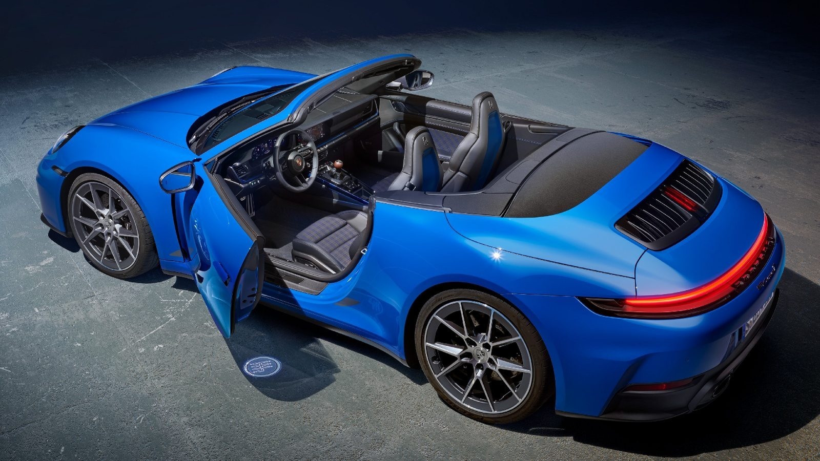 2025 Porsche 911 Cabrio Carrera T in blue with open driver's door