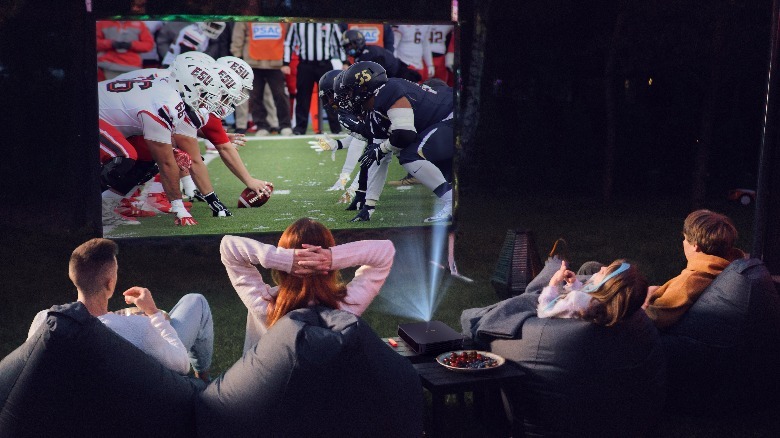 People watching sports outside using Dangbei Atom